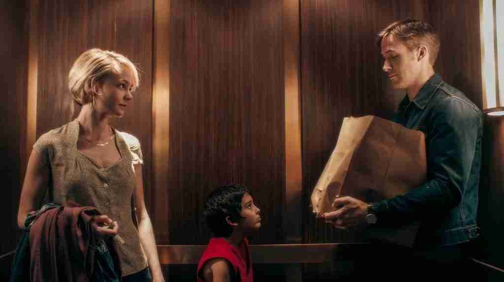 Drive beat sheet Act One elevator scene: Ryan Gosling as Driver handing groceries to Irene (Carey Mulligan) and her son Benicio in the apartment building elevator