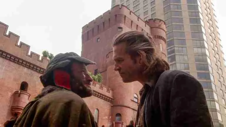 Robin Williams as Parry and Jeff Bridges as Jack in The Fisher King (1991), facing each other outside a castle-like building as Parry tries to enlist Jack’s help for the Grail quest – pivotal scene from the Fisher King beat sheet.