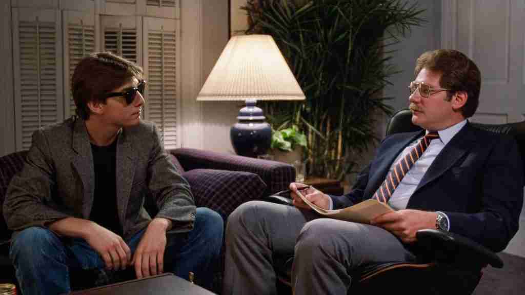 Joel Goodson wearing sunglasses during his Princeton interview with Bill Rutherford, a key moment in the Risky Business beat sheet.