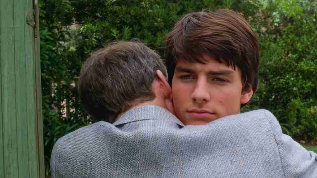 Joel Goodson's father hugging him after his Princeton acceptance, marking the ironic finale of a Risky Business beat sheet.