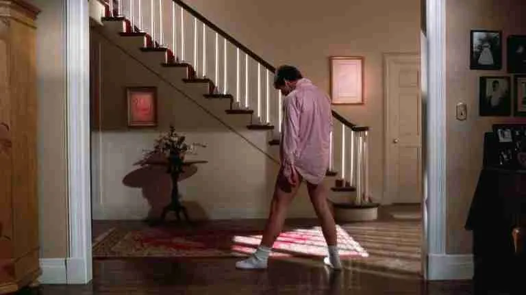 Tom Cruise dancing in a pink shirt and socks, illustrating the Catalyst moment in a Risky Business beat sheet.