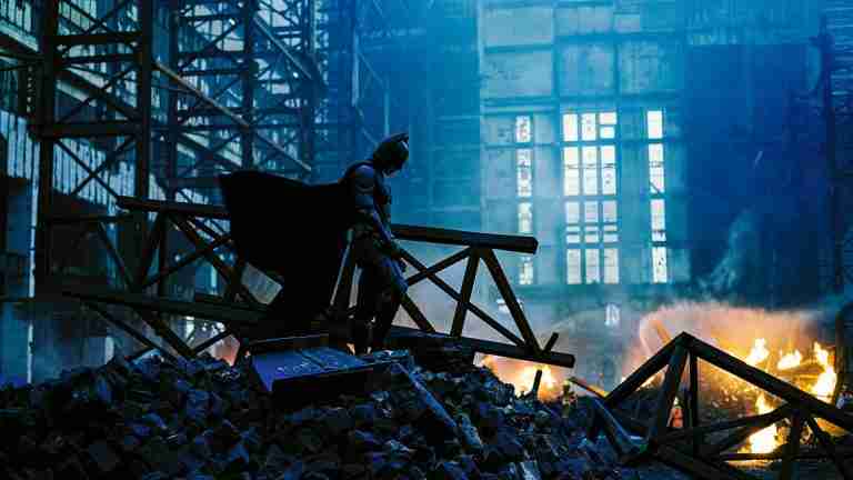 The pivotal "All Is Lost" beat: Batman surveys the wreckage where Rachel Dawes perished, marking the tragic turning point in the dark knight beat sheet.