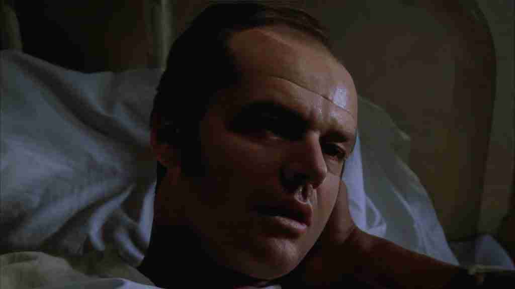 Chief Bromden (Will Sampson) grieving over the lobotomized R.P. McMurphy (Jack Nicholson) in his hospital bed in One Flew Over the Cuckoo's Nest (1975), moments before the mercy killing and final escape