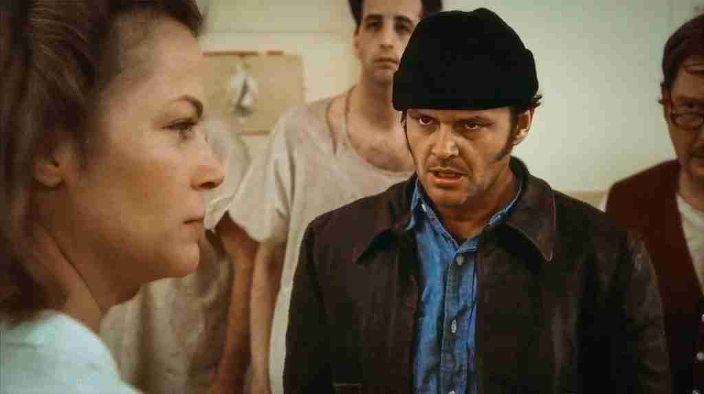 Jack Nicholson as R.P. McMurphy strangling Nurse Ratched in rage after Billy's suicide in One Flew Over the Cuckoo's Nest (1975), marking the irreversible commitment and explosive climax of Act Two