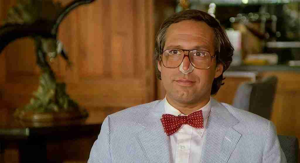 Fletch beat sheet – Chevy Chase as Irwin Fletcher in Boyd Aviation disguise scene from 1985 movie, striped suit red bow tie glasses nose bandage