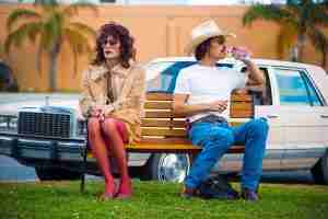 Ron Woodroof and Rayon sitting on a bench, representing the Dallas Buyers Club partnership.