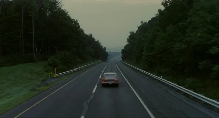 Will's car driving alone down a tree-lined highway in the final shot of Good Will Hunting.