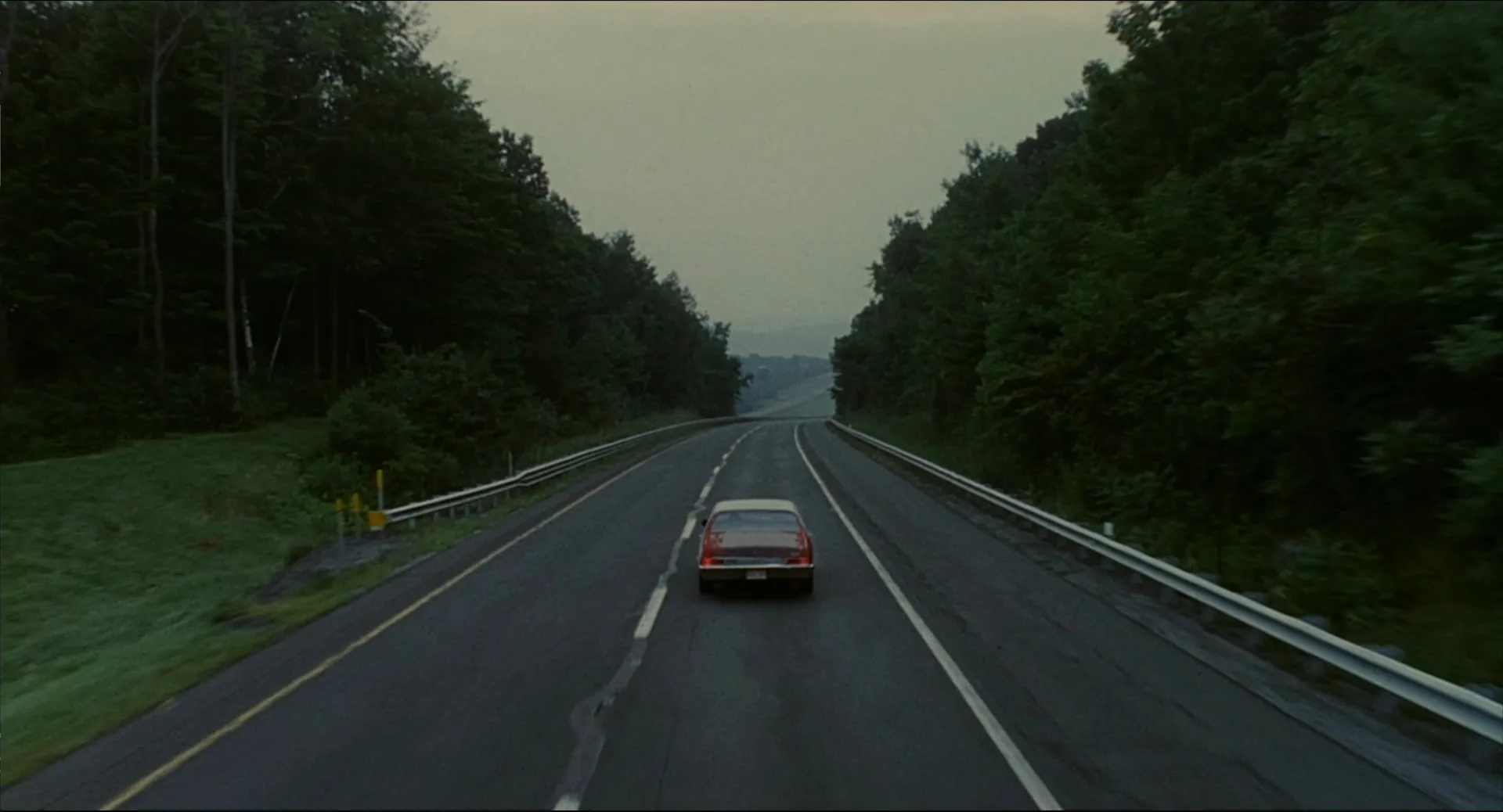 Will's car driving alone down a tree-lined highway in the final shot of Good Will Hunting.