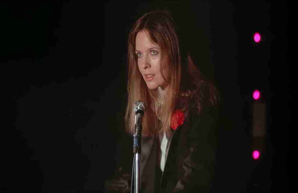 Annie Hall Diane Keaton singing "Seems Like Old Times" nightclub stage spotlight red flower confident performance 1977 film scene