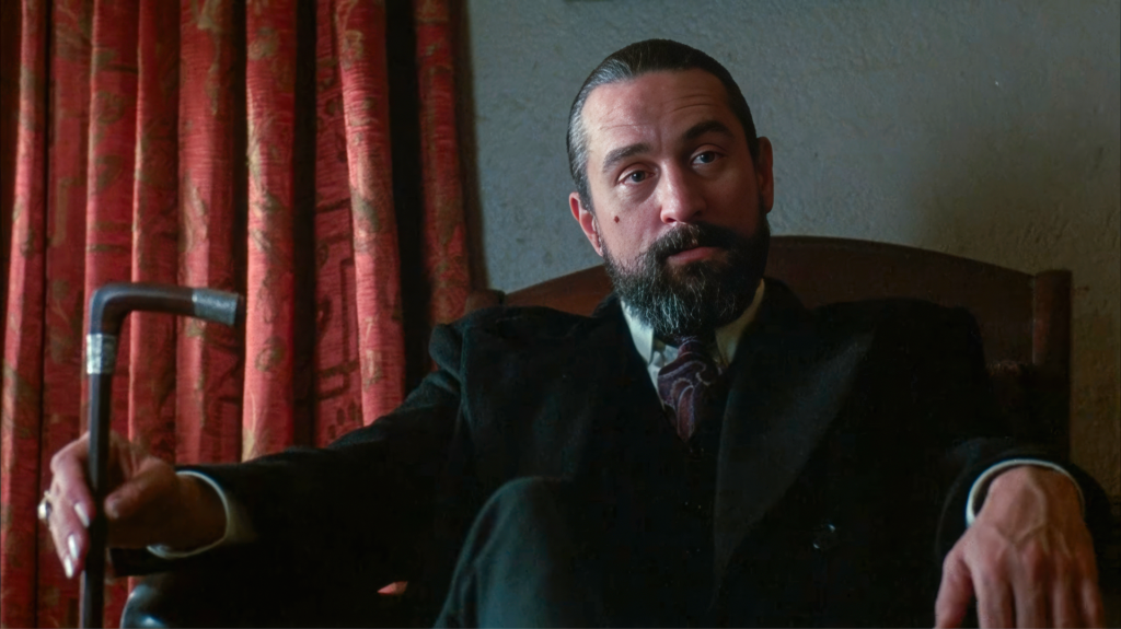 Angel Heart analysis — Robert De Niro as Louis Cyphre seated with silver-topped cane in the Kingdom Mission, his first appearance as the Devil in Alan Parker's 1987 film
