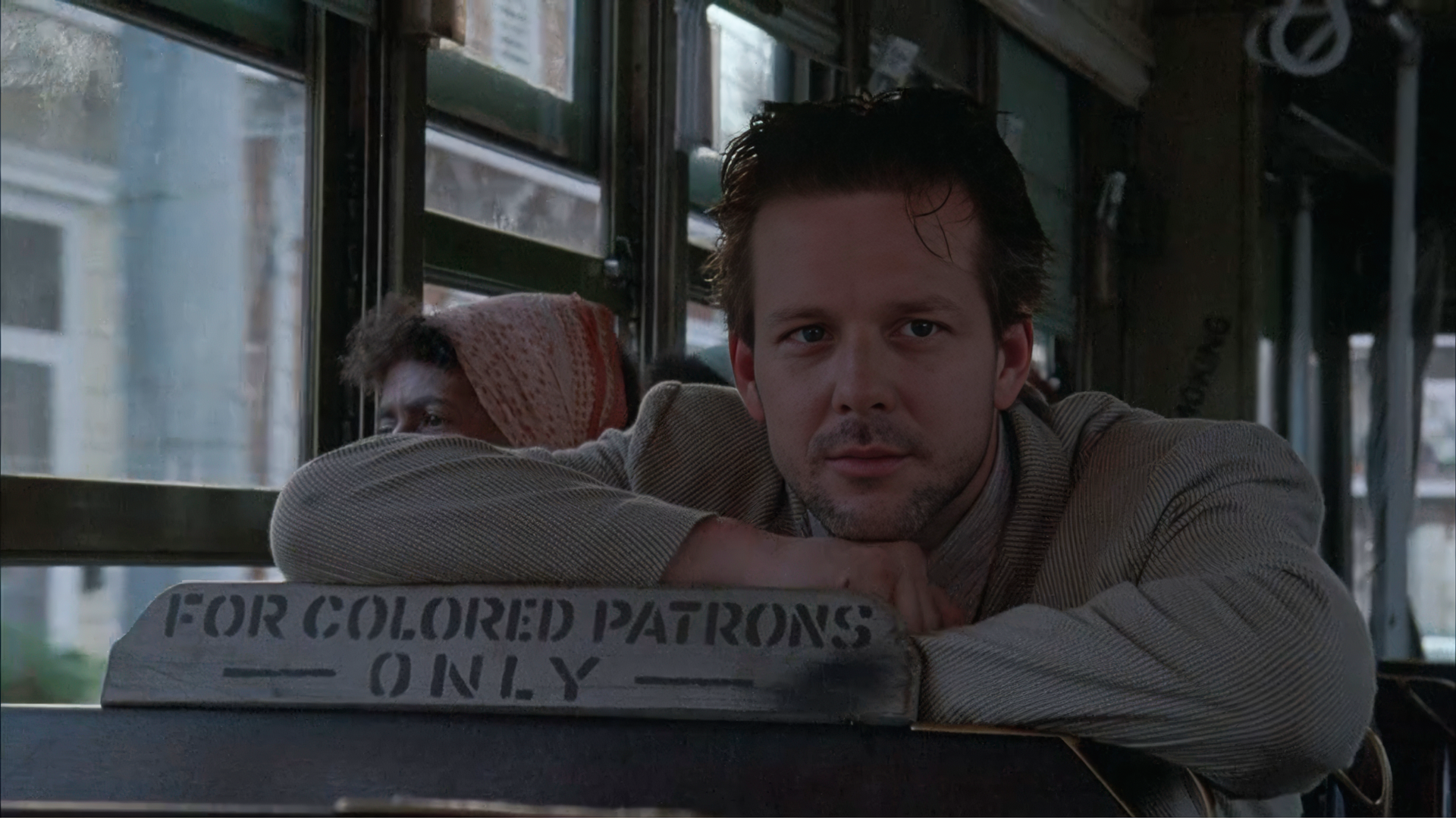 Angel Heart screenplay analysis — Mickey Rourke as Harry Angel seated in the colored patrons section of a New Orleans streetcar while following Margaret Krusemark, establishing the 1955 racial geography