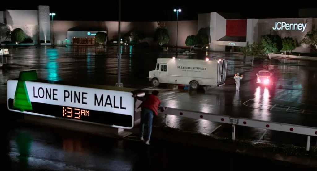 Lone Pine Mall sign with a single-tree logo in the same parking lot, Back to the Future foreshadowing payoff