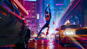 Miles Morales as Spider-Man swinging through a neon-lit Manhattan street between yellow cabs in Spider-Man: Into the Spider-Verse