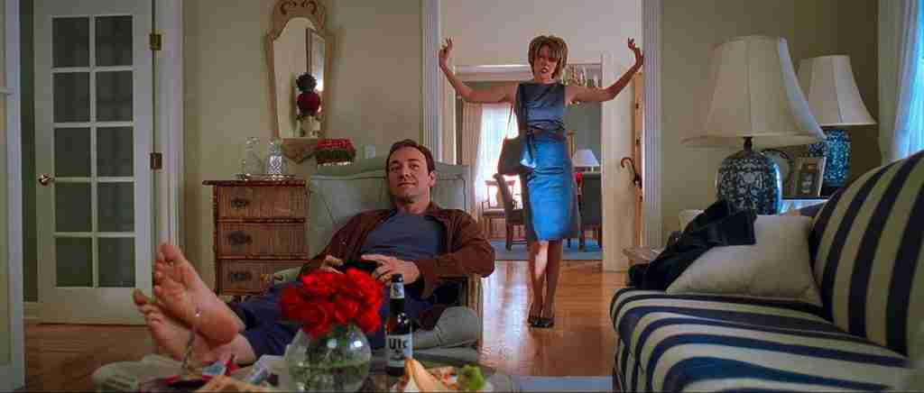 Lester Burnham enjoying his liberation with Carolyn standing rigidly, marking the Midpoint of the American Beauty Beat Sheet.