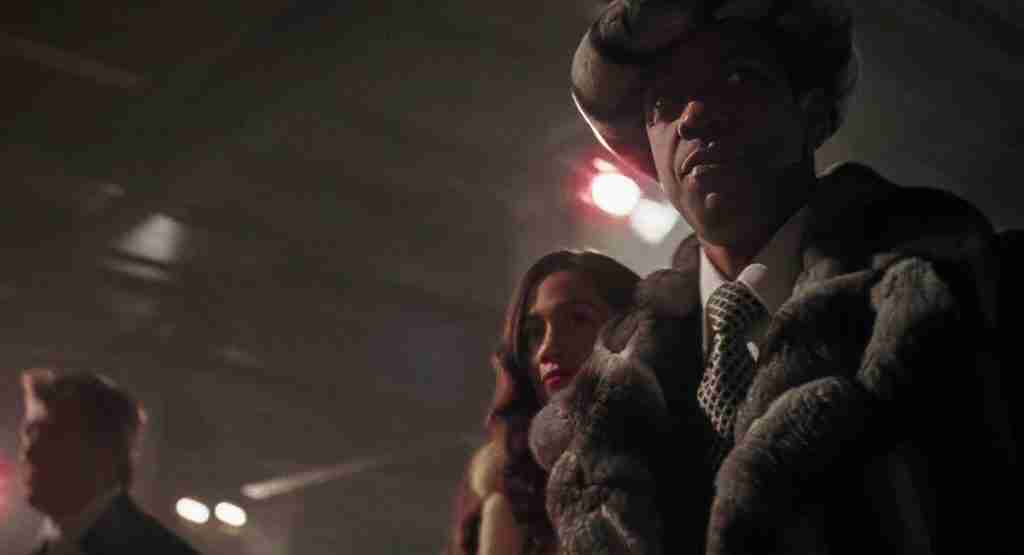 Iconic image of Frank Lucas in chinchilla coat, representing hubris and structural downfall.