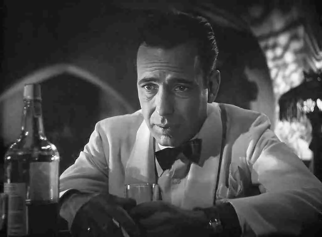 Close-up of Rick Blaine, heartbroken and cynical, drinking alone in his cafe. Casablanca beat sheet Act Two, Part A.