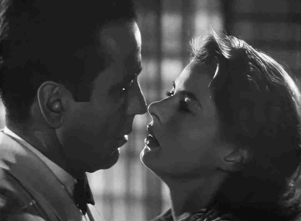 Rick and Ilsa in a passionate embrace during her emotional confession in Rick's apartment, marking the All Is Lost moment.