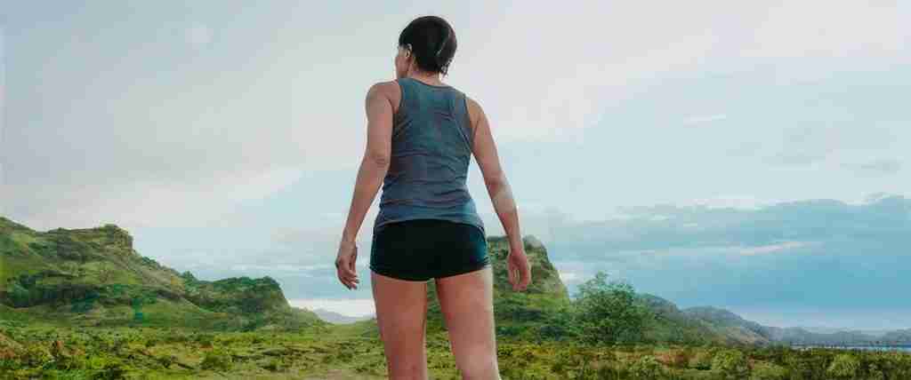 Dr. Ryan Stone standing triumphantly on Earth's muddy shore after her return from space.
