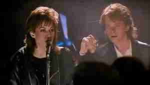 Iconic final scene of Joan Jett (Patti Rasnick) and Michael J. Fox (Joe Rasnick) holding hands on stage after performing the song "Light of Day."