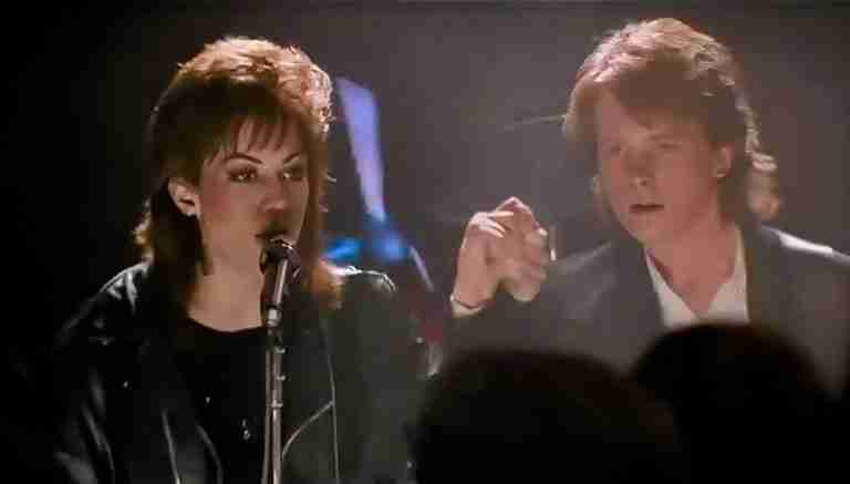 Iconic final scene of Joan Jett (Patti Rasnick) and Michael J. Fox (Joe Rasnick) holding hands on stage after performing the song "Light of Day."