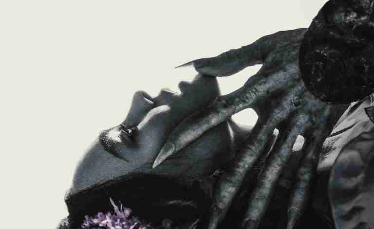 Count Orlok's grotesque, clawed hand reaches for Ellen Hutter's face, symbolizing the main conflict and supernatural possession.