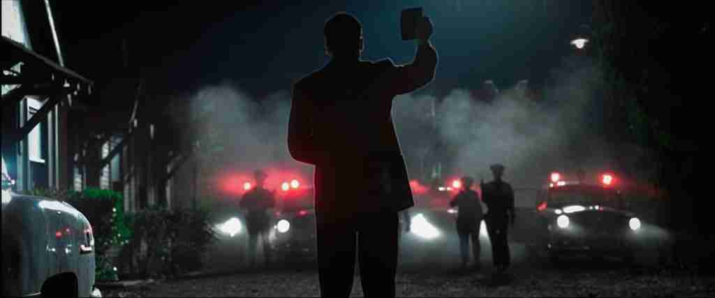 Detective Ed Exley in the Final Image, having violated his own ethical code to achieve justice, directly referencing the "Rollo Tomasi" climax.