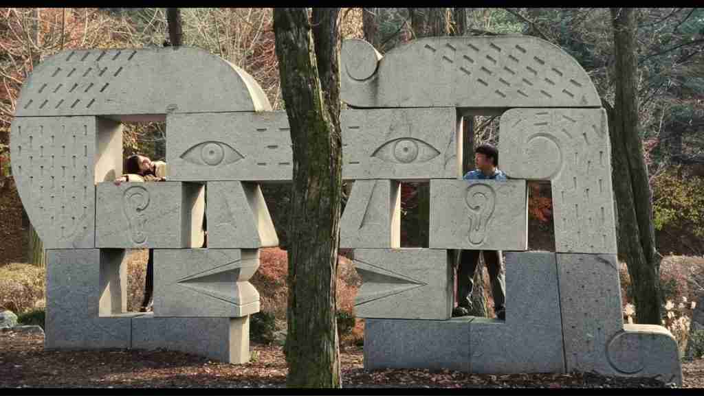 Past Lives analysis childhood sculpture Seoul Na Young Hae Sung facing together