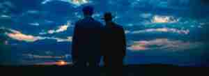 Sinners analysis – twins Smoke and Stack silhouette at sunset in Ryan Coogler’s vampire horror film