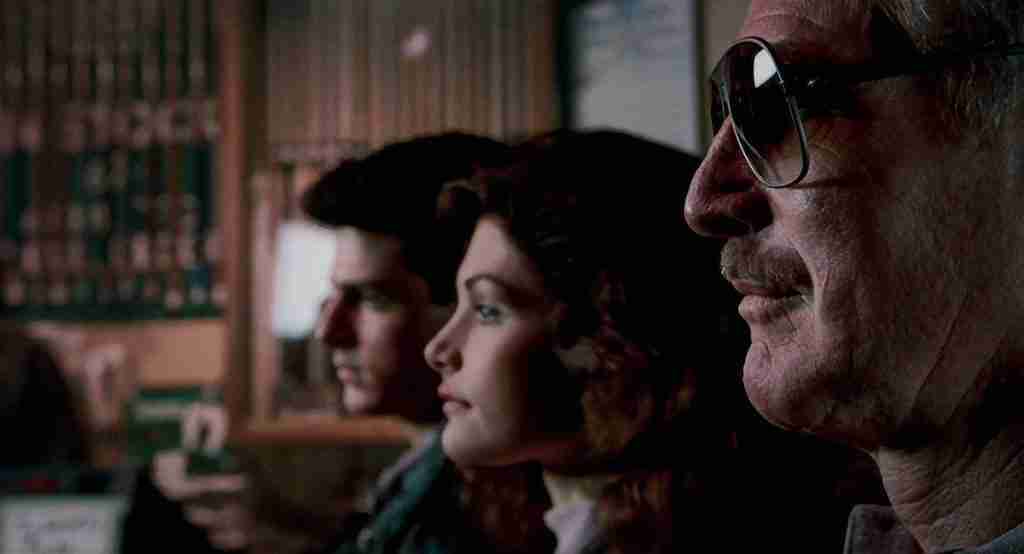 The Color of Money analysis image: Paul Newman as Eddie Felson, Tom Cruise as Vincent Lauria, and Mary Elizabeth Mastrantonio as Carmen sitting in profile at pool hall counter