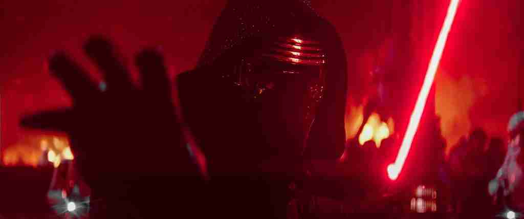 Adam Driver as Kylo Ren extending hand with ignited red lightsaber – The Force Awakens analysis of character screenwriting lessons