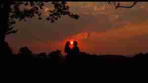 Silhouette of Westley and Buttercup kissing against a vibrant sunset in The Princess Bride, symbolizing "As you wish" and true love.