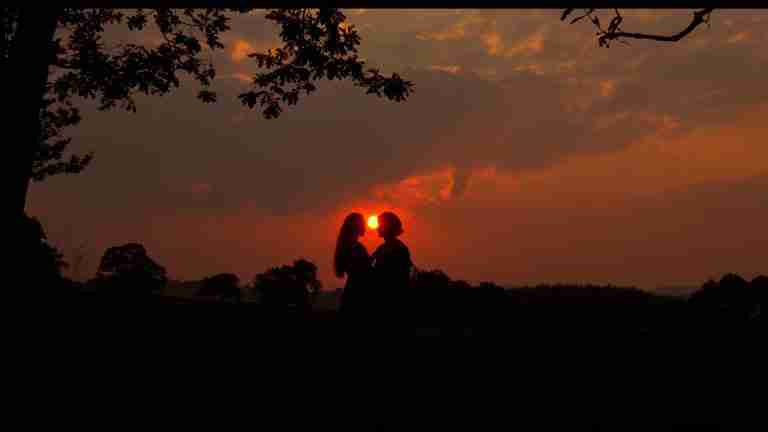 Silhouette of Westley and Buttercup kissing against a vibrant sunset in The Princess Bride, symbolizing "As you wish" and true love.