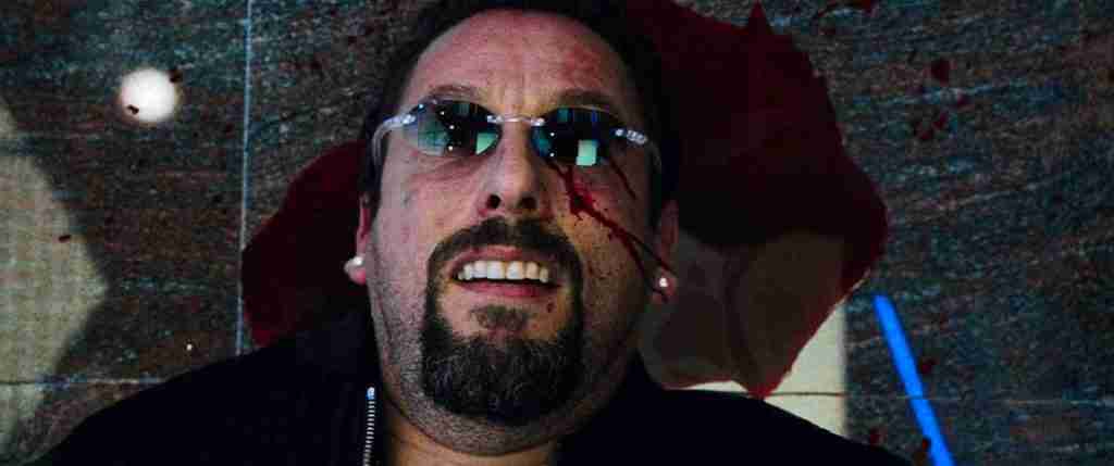 The final shot of Howard Ratner (Adam Sandler) lying on the floor with a slight smile in an Uncut Gems analysis of the film's tragic ending.