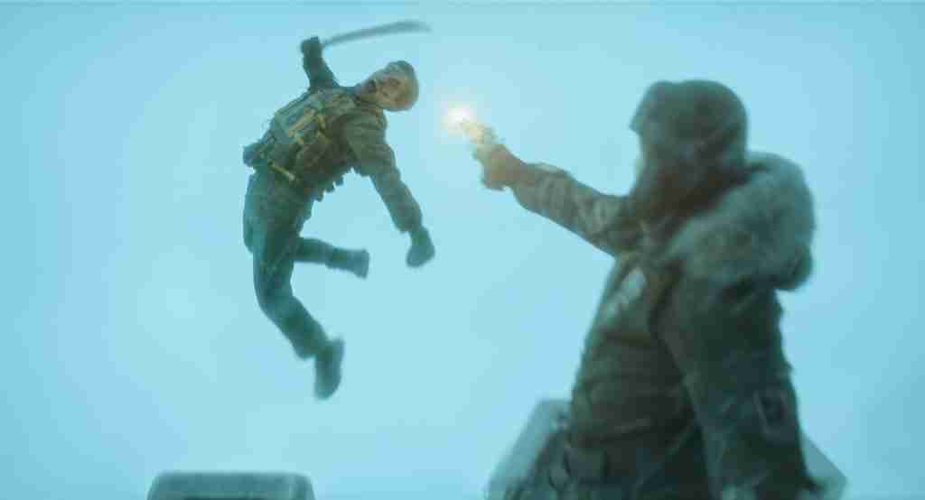Mickey 17 analysis Save the Cat section image: Robert Pattinson as Mickey 18 mid-leap attack with machete in snowy Niflheim, gunfire flash, climax sacrifice scene