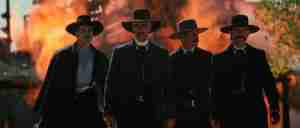 Tombstone analysis: Iconic walk to the O.K. Corral scene with fire in background – Wyatt Earp, Virgil, Morgan, and Doc Holliday