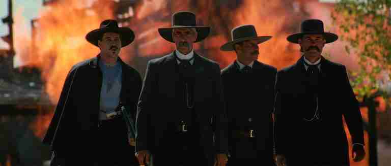 Tombstone analysis: Iconic walk to the O.K. Corral scene with fire in background – Wyatt Earp, Virgil, Morgan, and Doc Holliday