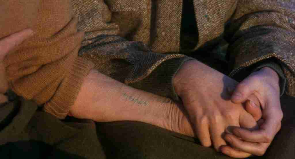 A close-up shot of the tattooed identification number on Maude's arm, revealing her history as a Holocaust survivor.