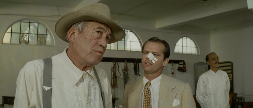 Noah Cross in embroidered guayabera shirt, grey suspenders, and silverbelly hat — Anthea Sylbert's Chinatown costume design showing the visual language of robber baron power