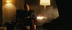 Anton Chigurh firing the bolt gun in No Country for Old Men
