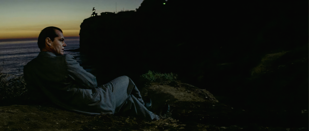 Jake Gittes seated alone on the cliffs at Point Fermin at dusk watching Hollis Mulwray, an early scene in the film adapted from the Robert Towne Chinatown screenplay