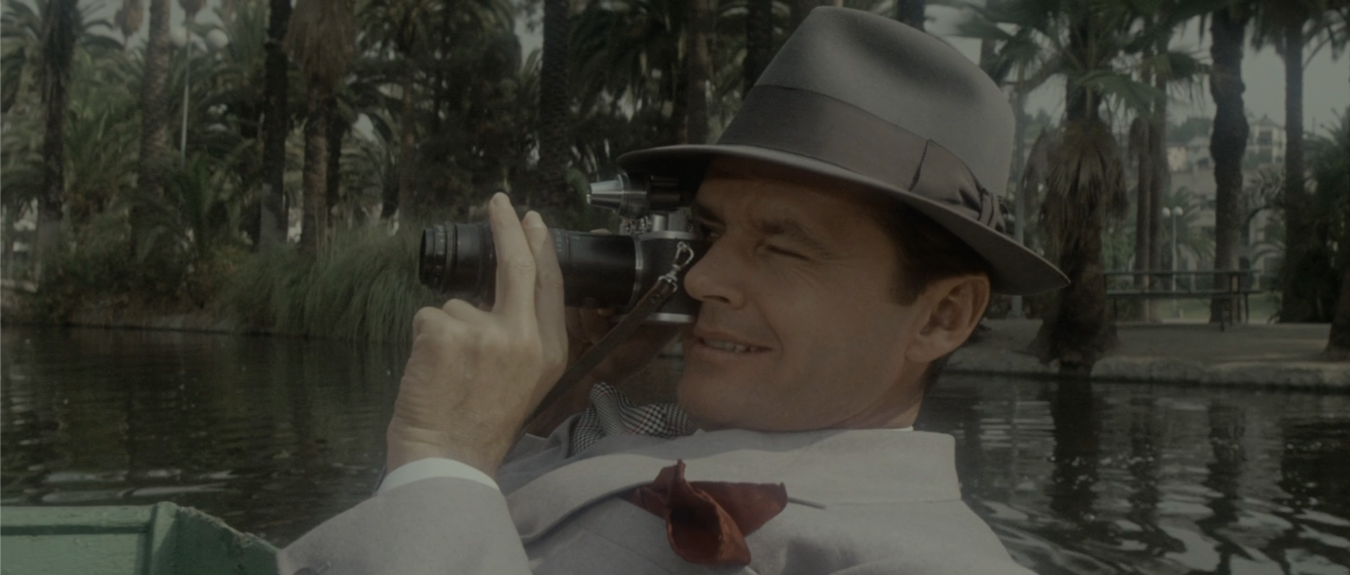 Jake Gittes photographing Hollis Mulwray and Katherine at Echo Park in Chinatown 1974