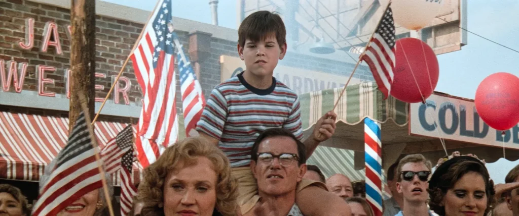 oung Ron Kovic on his father's shoulders at a Fourth of July parade in Born on the Fourth of July