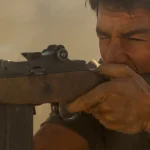 Tom Cruise as Ron Kovic firing a rifle in Born on the Fourth of July