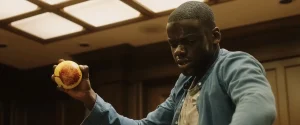 A bloodied Chris Washington grips a bocce ball in the games room in Get Out