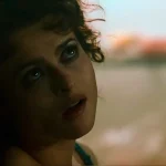 Close-up of Helena Bonham Carter as Marla Singer in soft morning light, hair tousled, looking up and off-frame with a guarded expression, from Fight Club.