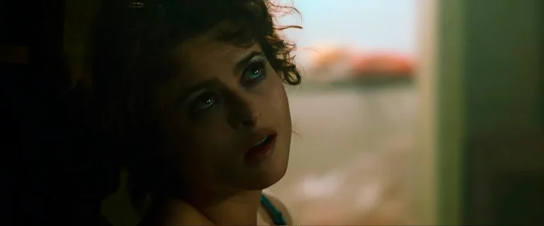 Close-up of Helena Bonham Carter as Marla Singer in soft morning light, hair tousled, looking up and off-frame with a guarded expression, from Fight Club.